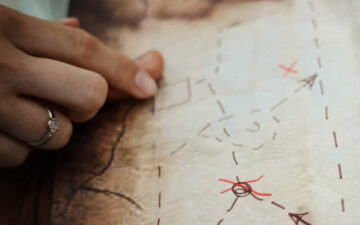 Fingers pointing on a treasure map
